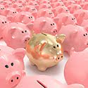 A group of piggy banks on a white floor. Most are colored pink. One is a golden color.