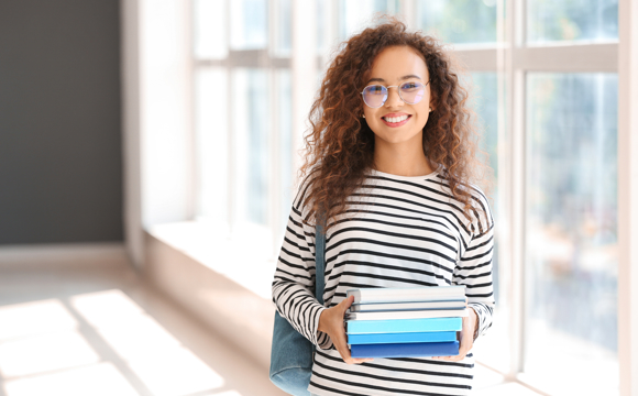 A student holding her backpack.