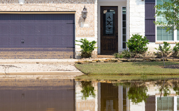 A home with a flood receding right in front of it.