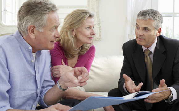An older couple meeting with a man in a suit.