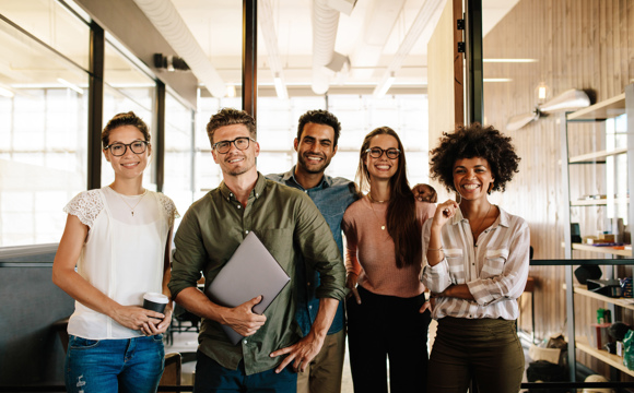 A small team of smiling business professionals