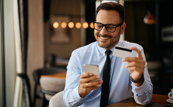 A business man holding a credit card