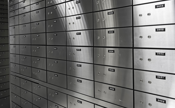 A wall of silver safe deposit boxes.