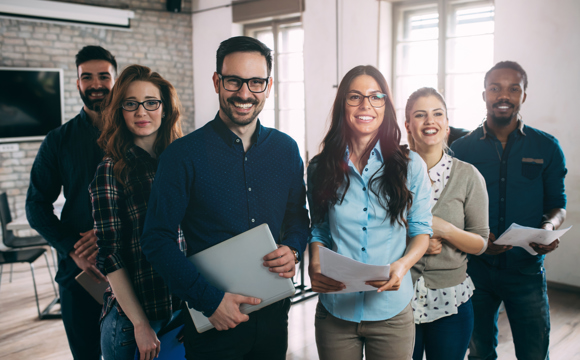 A smiling team of business professionals standing in a line